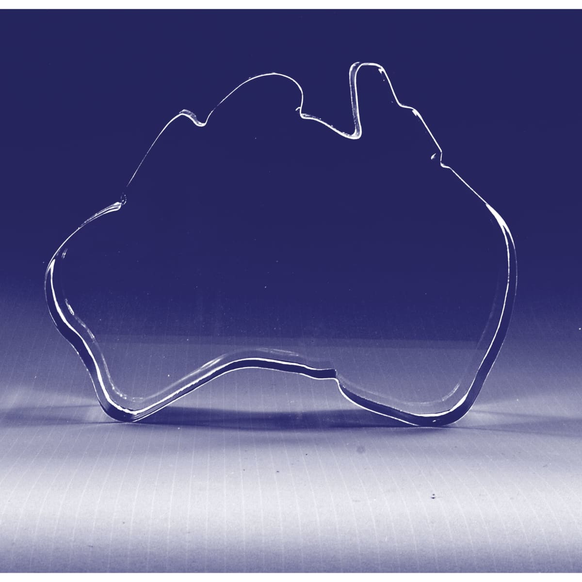 A 3D crystal shaped like Australia, clear with smooth edges, showcasing the country's outline.