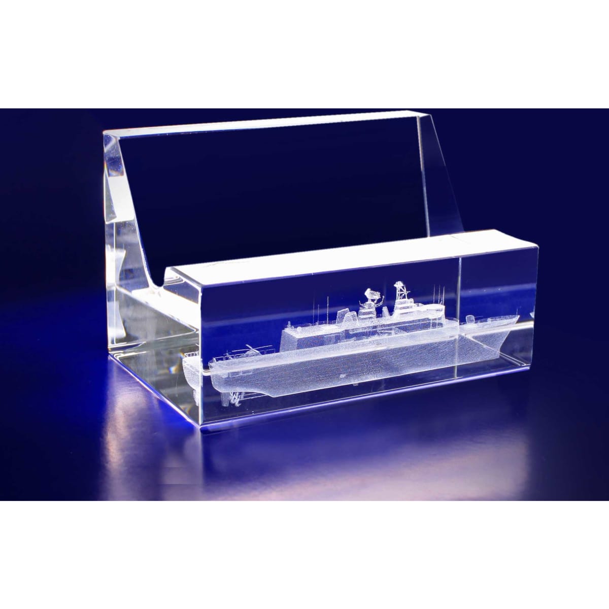 A 3D crystal business card holder in clear acrylic, featuring an intricate design of a ship inside.
