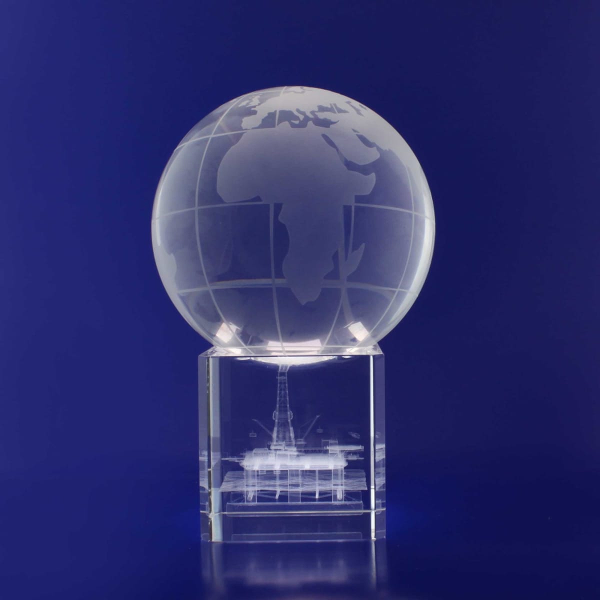 A 3D crystal globe with detailed continents, displayed on a clear base, against a blue background.
