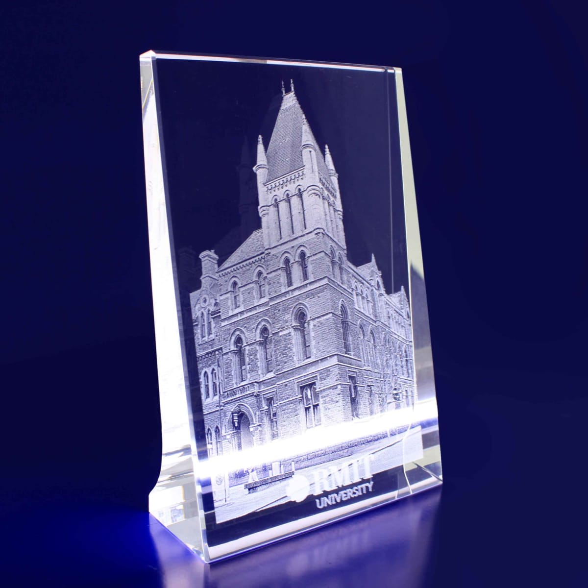 A clear 3D crystal photocrystal featuring a detailed building engraving with a logo at the base.