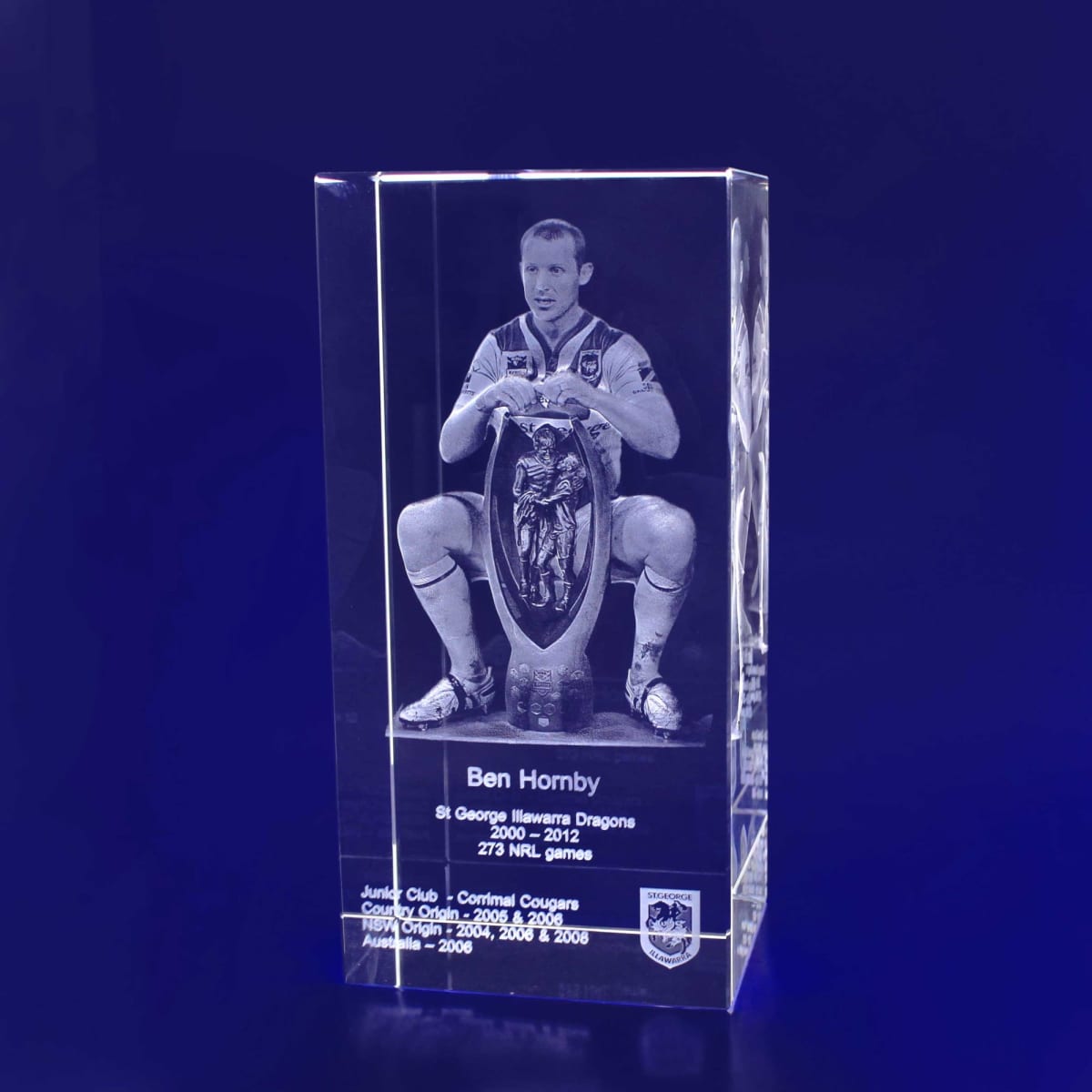 A clear 3D crystal rectangle featuring a detailed etched image of a rugby player, with a logo at the base.