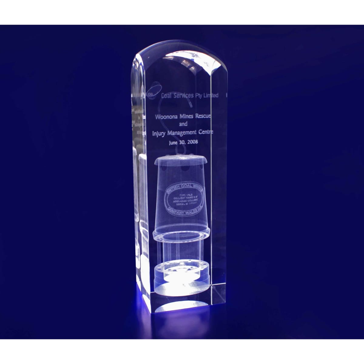 A 3D crystal dome top tower trophy in clear glass, featuring engraved text and a logo.