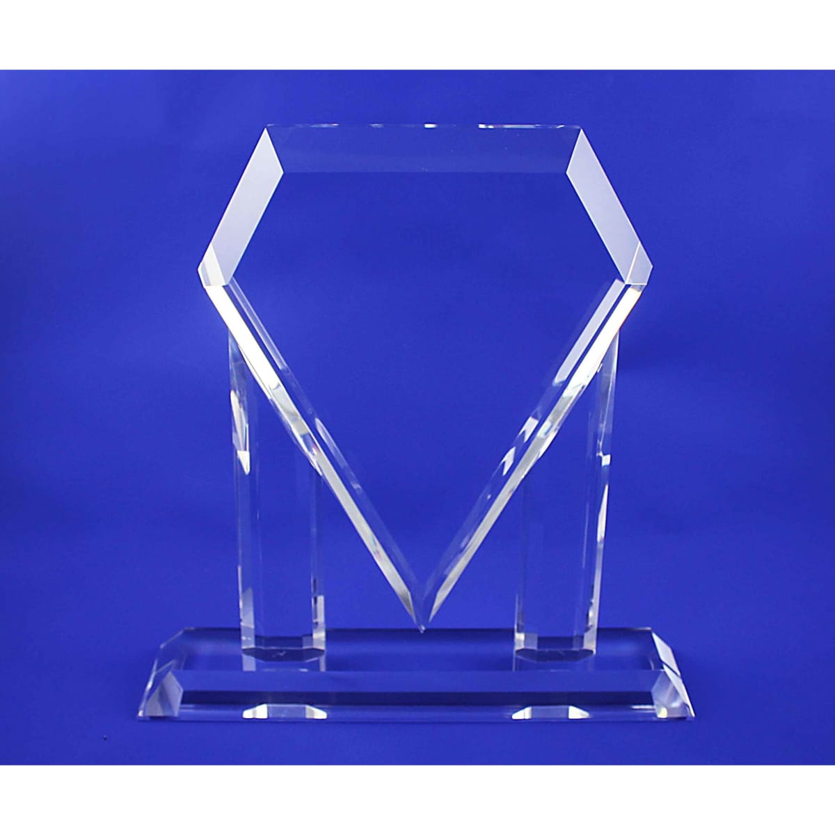 A clear, crystal trophy with a unique diamond shape, set against a blue background.