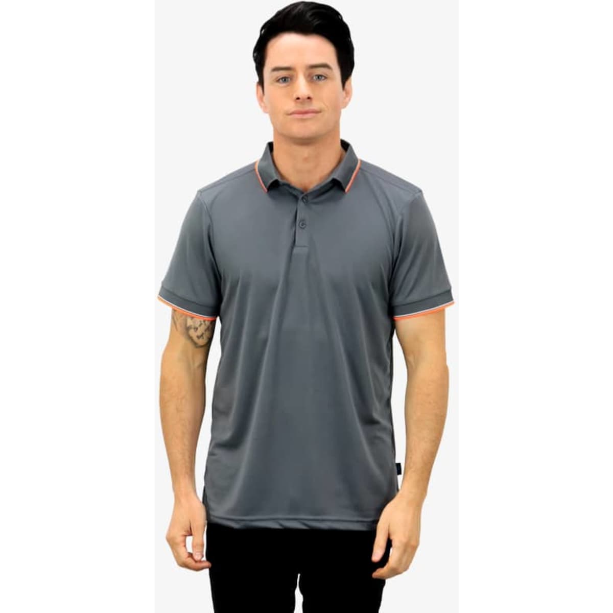 A grey polo shirt with orange trim, featuring a collar and a button placket, worn by a model.