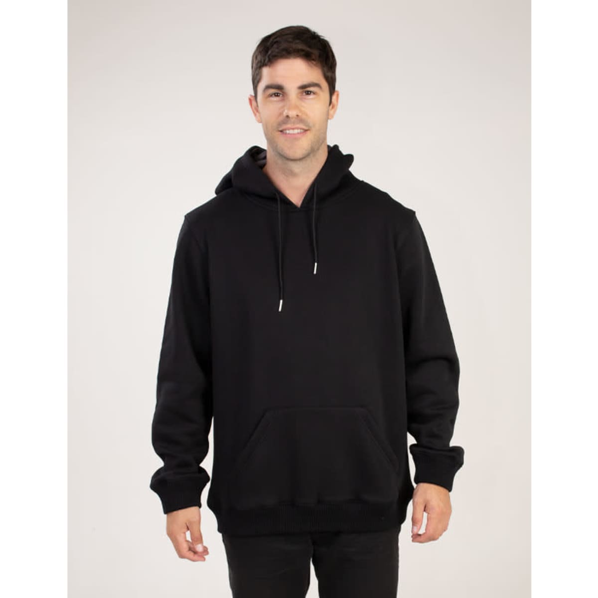 A black hoodie with a front pocket and drawstrings, featuring a logo on the chest. Model stands against a neutral background.