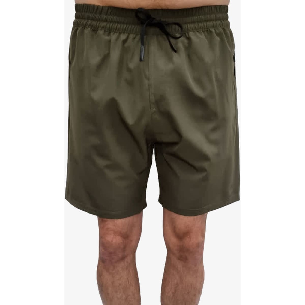 Olive green sports shorts featuring an elastic waistband and side pockets, with a logo present on the garment.
