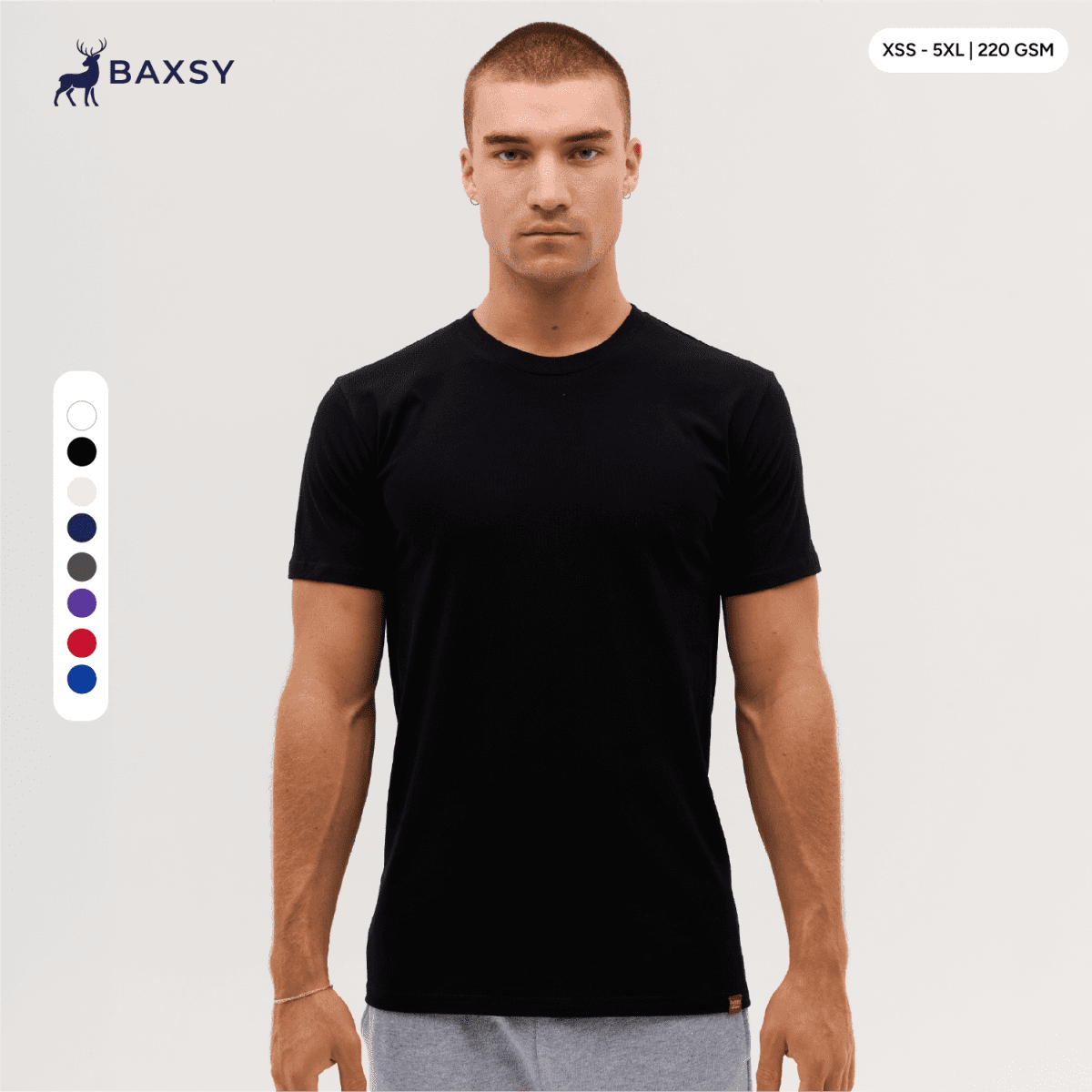 A plain black T-shirt displayed on a model, featuring a logo and available in various sizes.