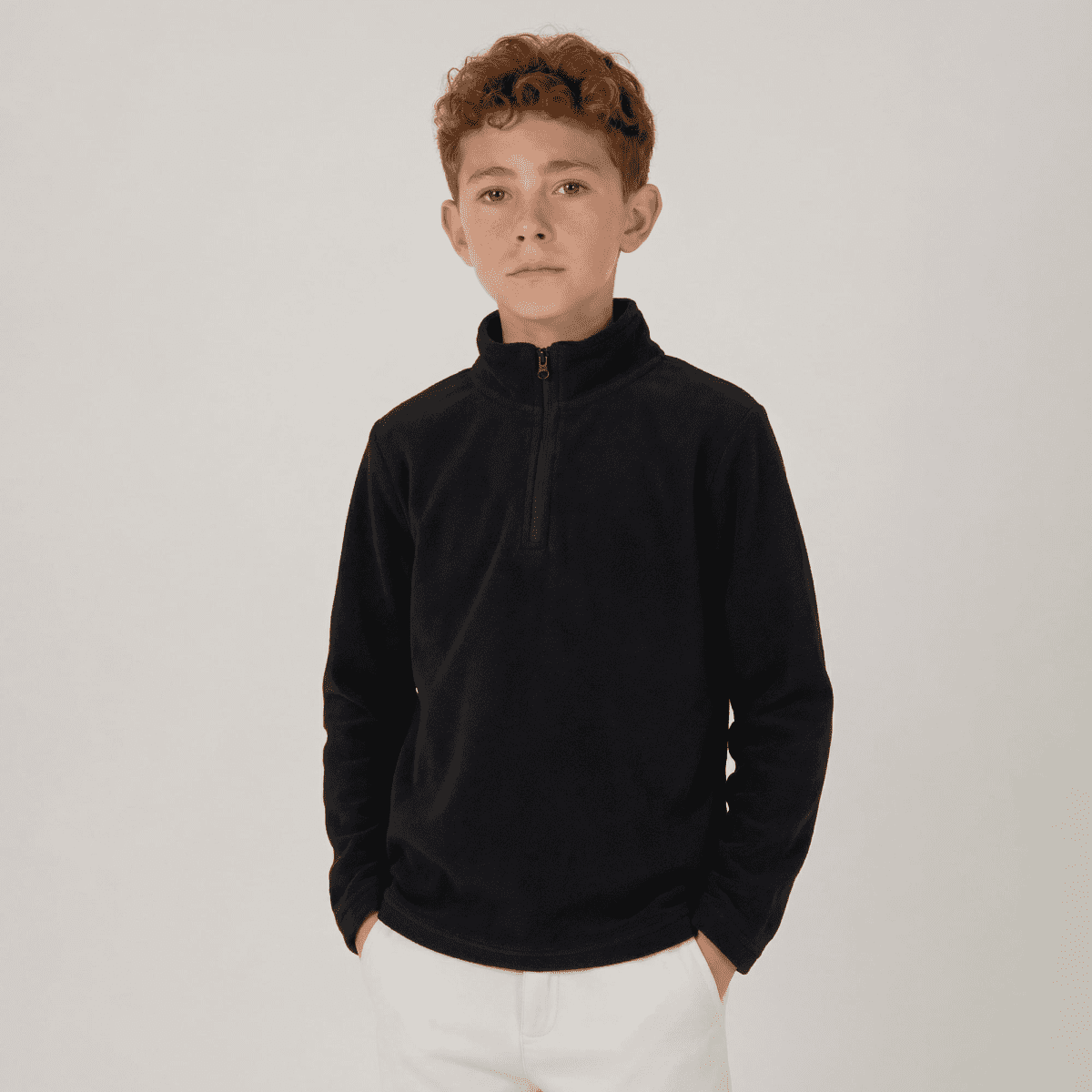 A youth polar fleece 1/4 zip in navy, featuring a high collar and long sleeves, with a logo present.
