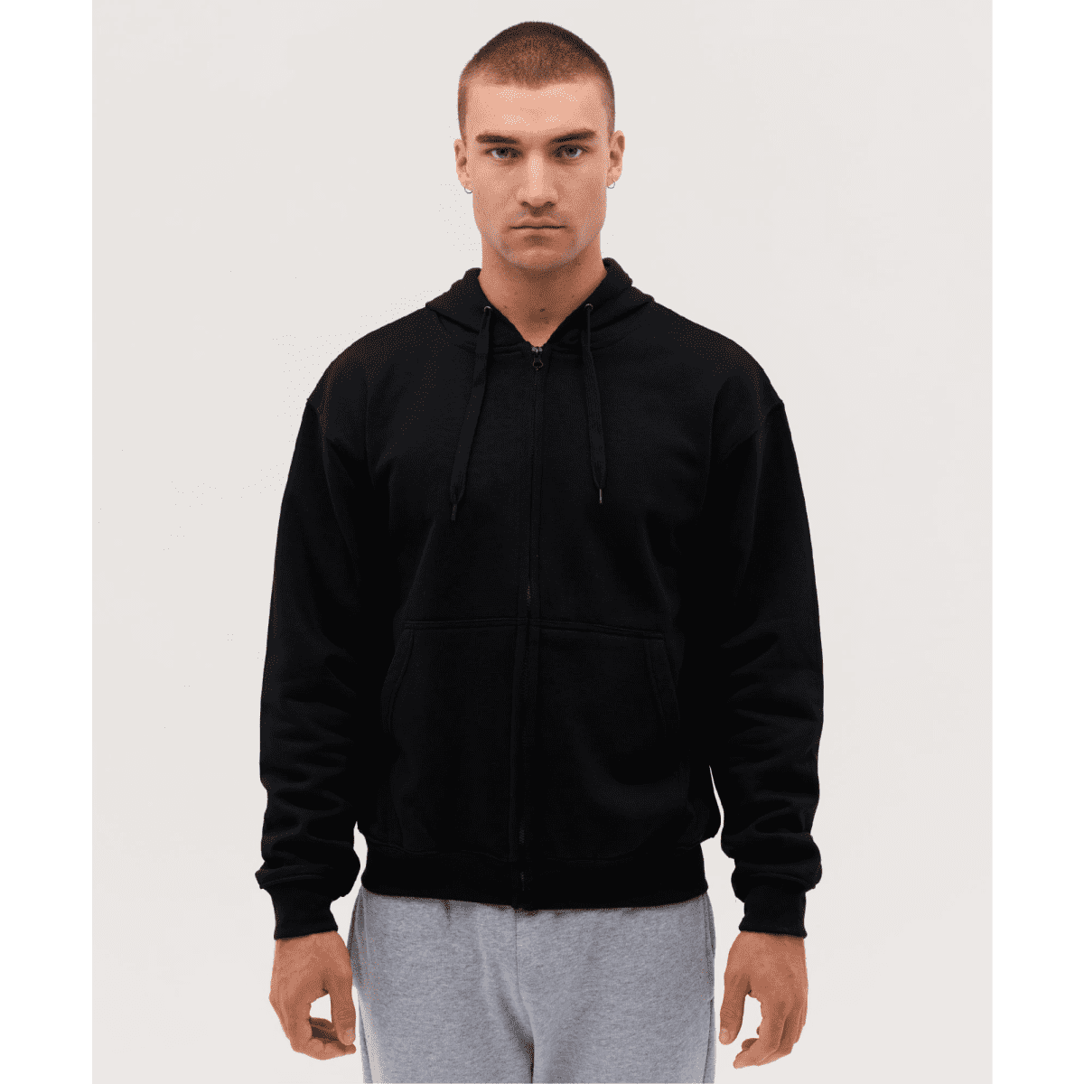 A black zip-up hooded sweatshirt on a model, featuring a front zipper and drawstring hood.
