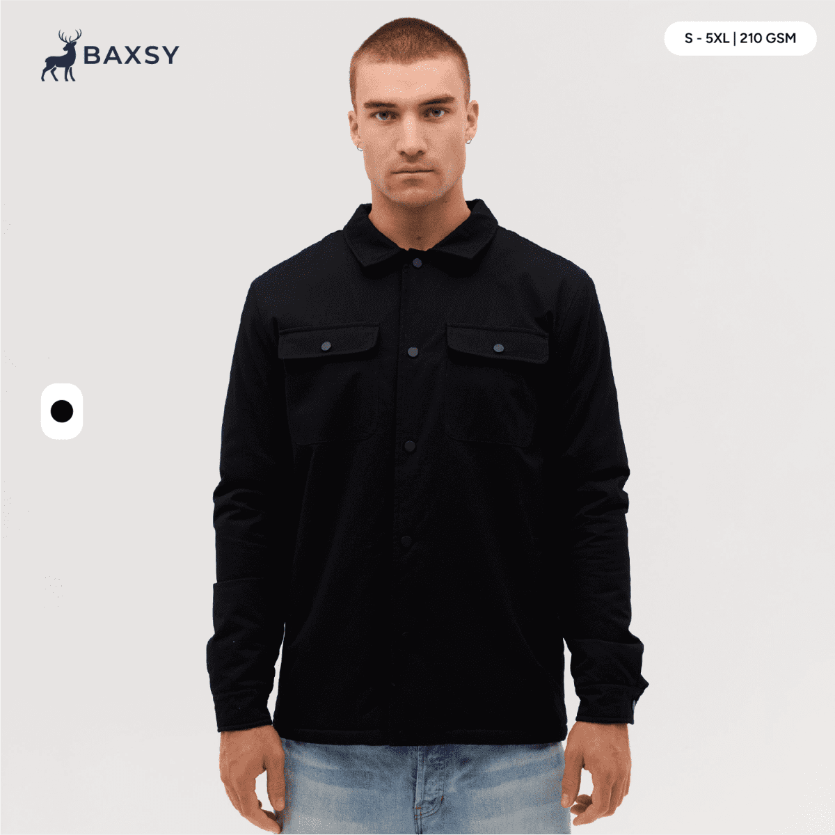A man wearing a black Studio Canvas Jacket, featuring pockets and a collared design.