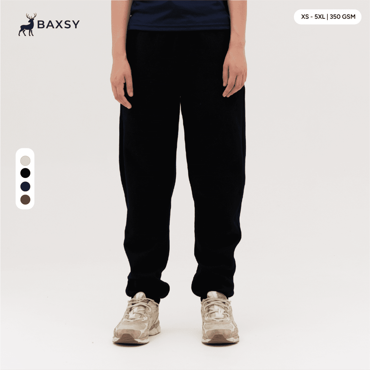 Black track pants displayed on a person, featuring a casual fit and an elastic waistband, with a logo visible.
