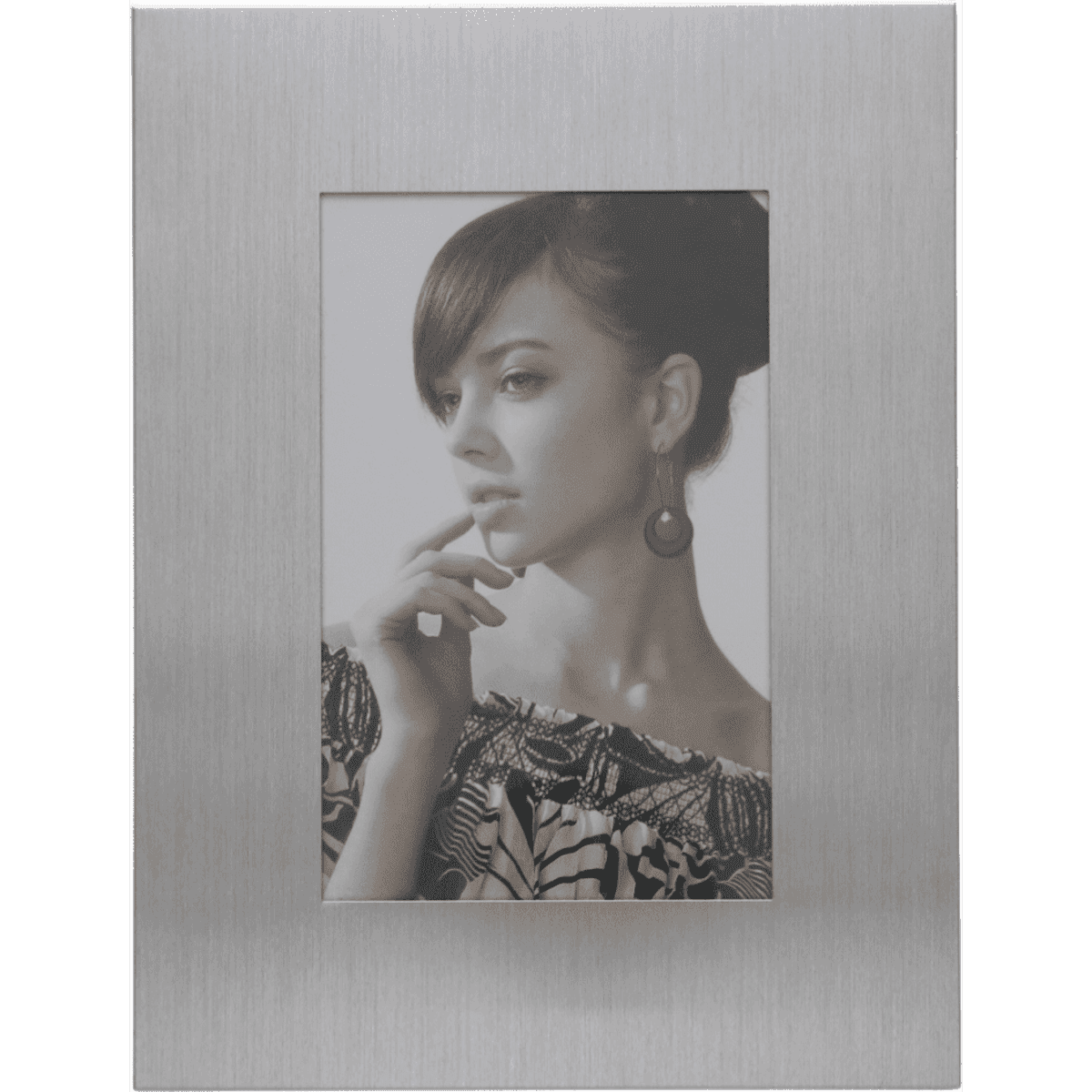 A silver photo frame featuring a portrait of a woman with dark hair and earrings.