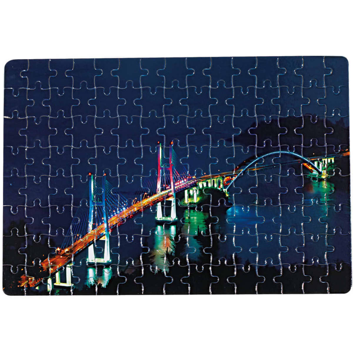 A jigsaw puzzle featuring a brightly lit bridge at night, with various blue and green tones. It has a logo on the corner.