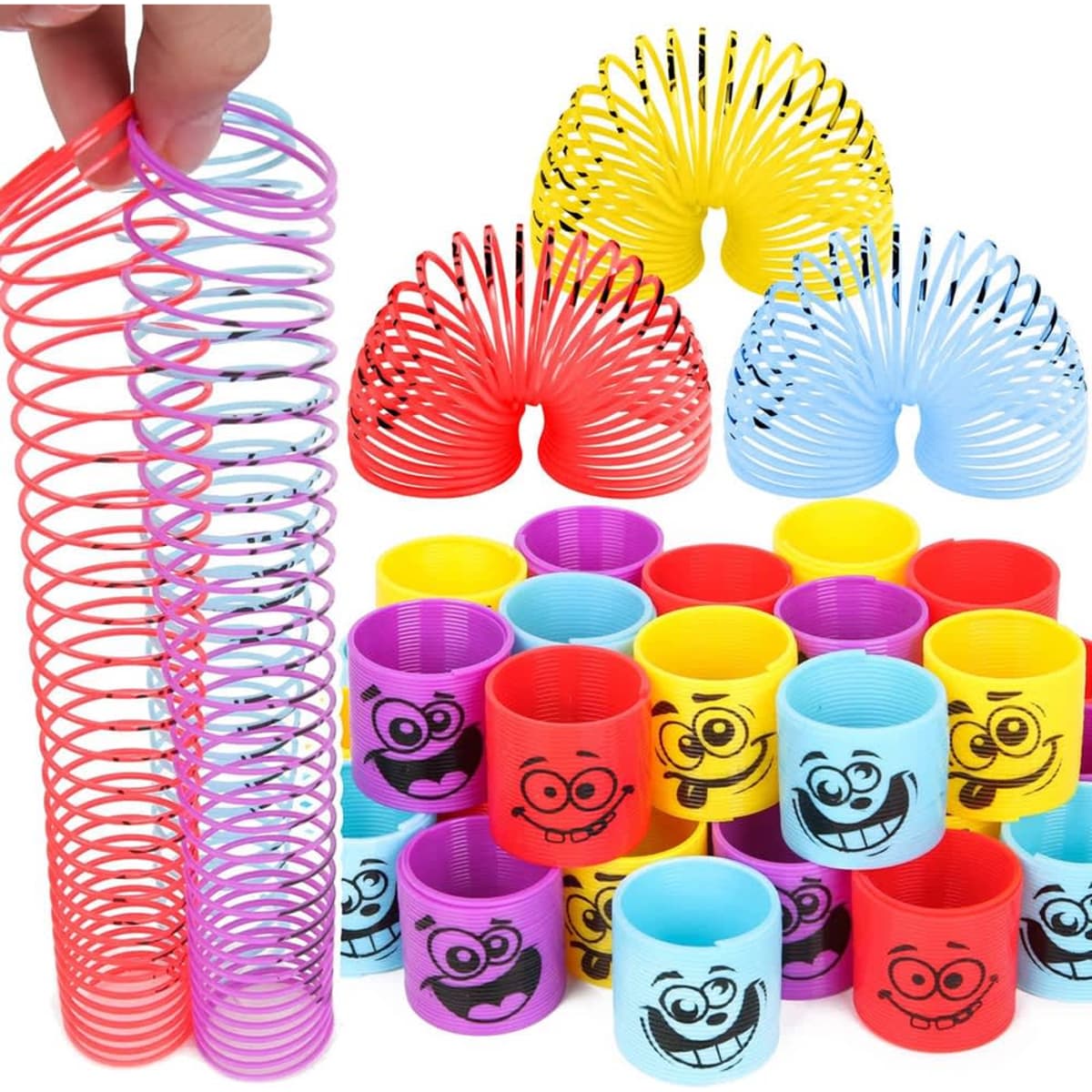 A collection of colourful coil spring toys, including pink, red, yellow, and blue, featuring smiling cartoon faces.