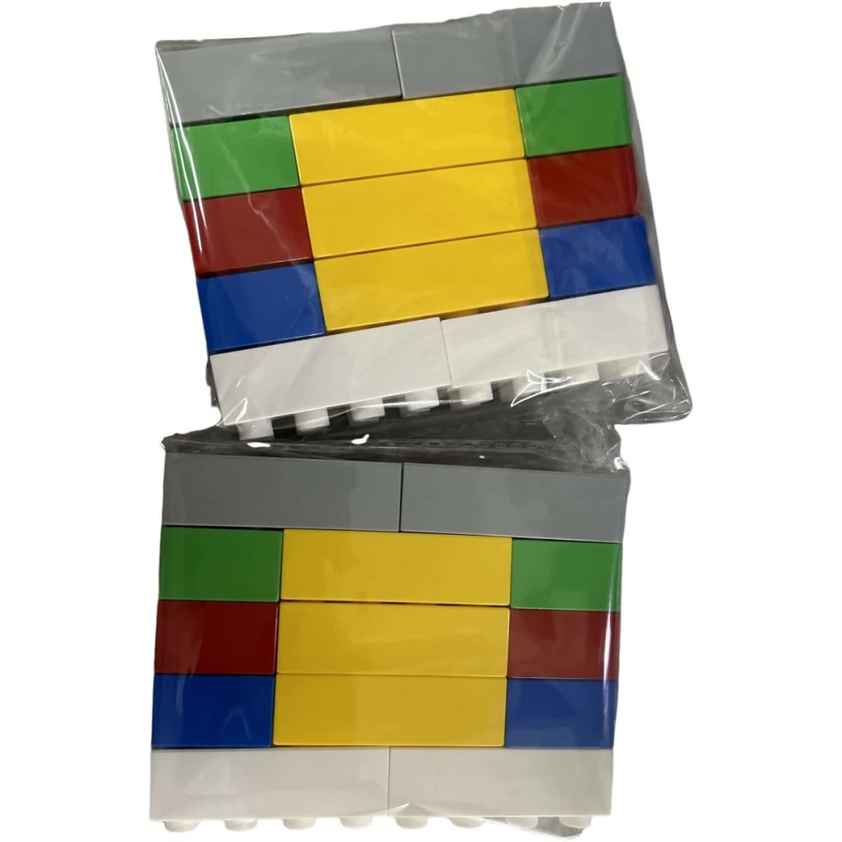 Two packs of building block toys in grey, yellow, green, red, and blue colours. Each pack is wrapped in clear plastic.