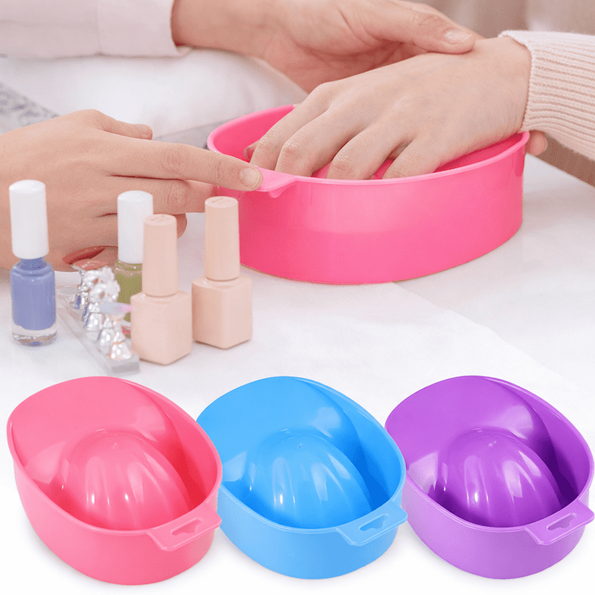 A set of pink, blue, and purple nail soak bowls with nail polish bottles in the background.