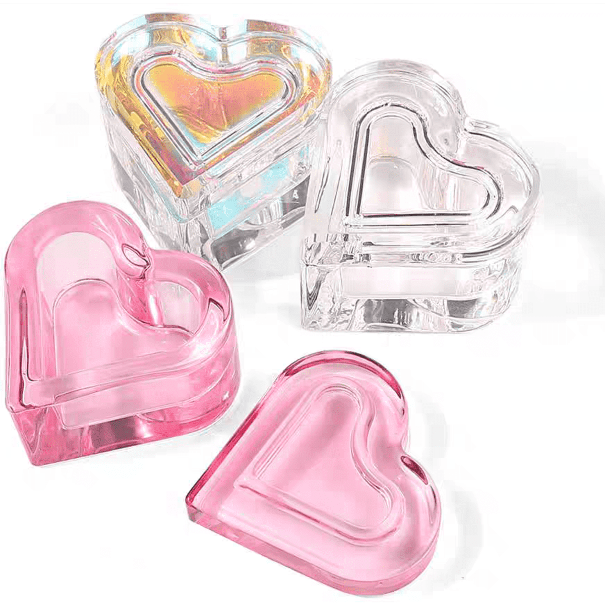 A set of heart-shaped containers in pink, clear, and iridescent colours, with a smooth, glossy finish.