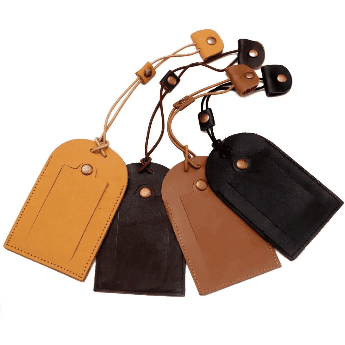 A set of four luggage tags in yellow, brown, and black, featuring leather material and attached straps.
