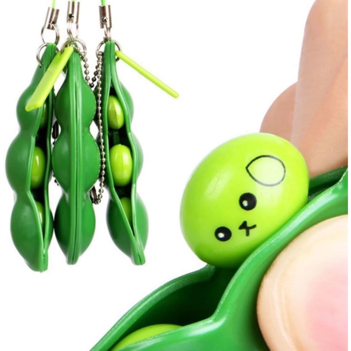 A green soybean stress-relieving keychain featuring three pea-shaped charms with a cute face, attached to a silver chain.