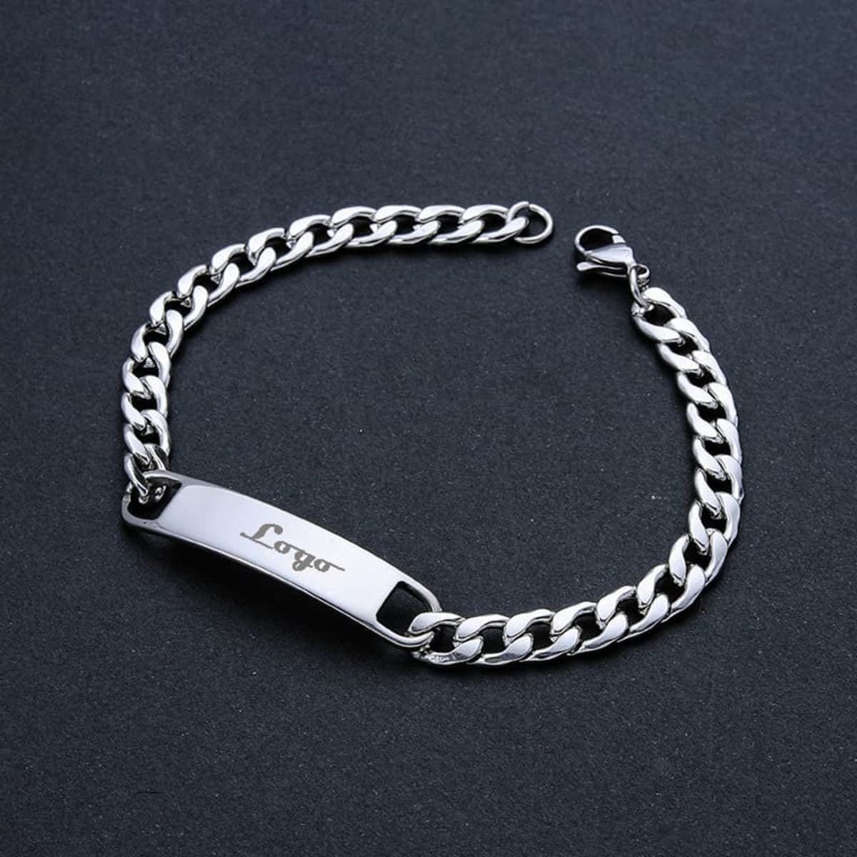 A stainless steel bracelet with a shiny silver finish and a logo on the central plate.