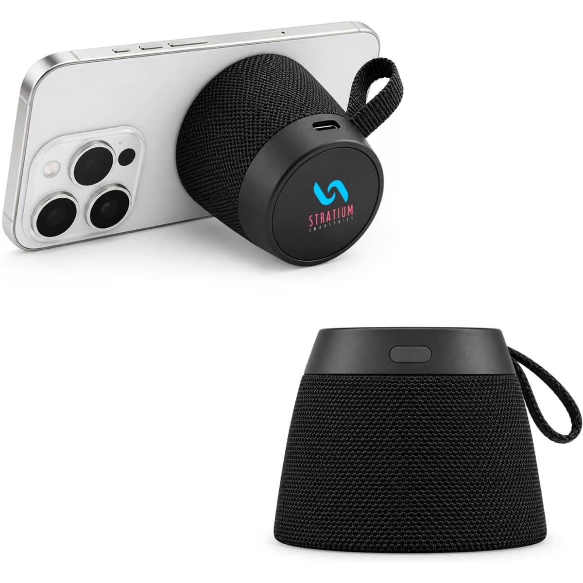 A black portable speaker with a fabric design, displayed with a phone leaning against it. Features a logo.