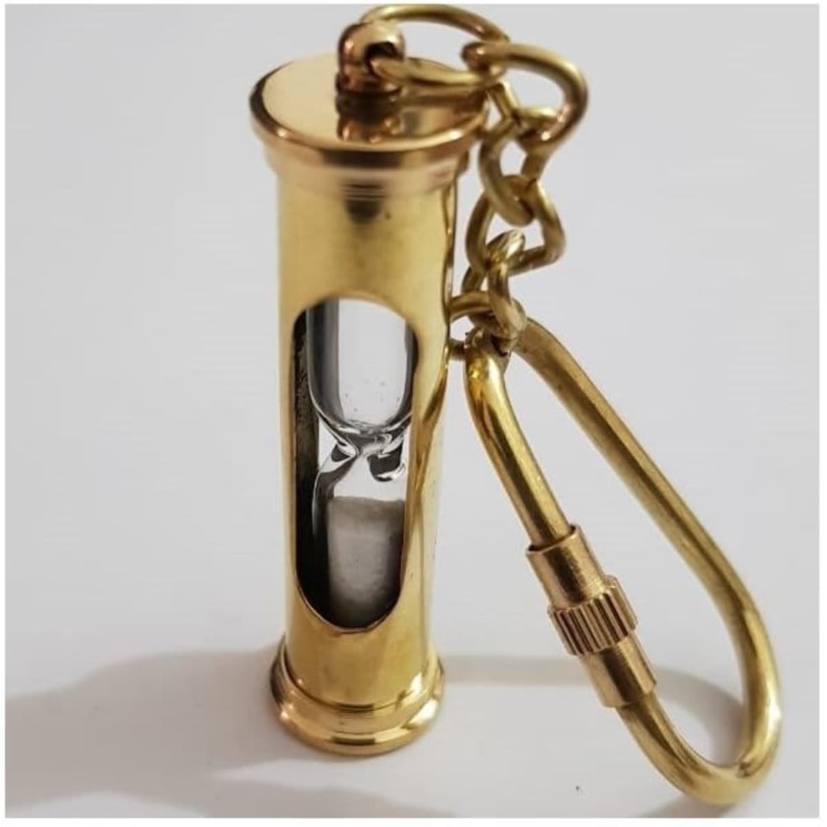 A metallic gold telescopic keyring featuring a transparent window and attached carabiner.