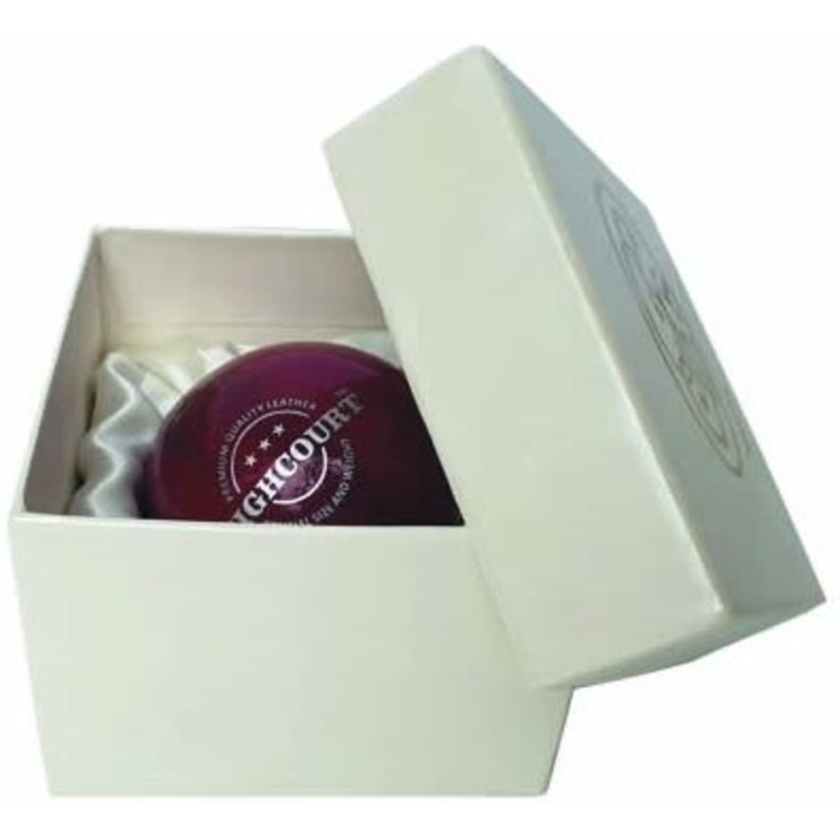 A cricket ball in a cream gift box with decorative padding inside. The ball is a deep red colour and has a logo.