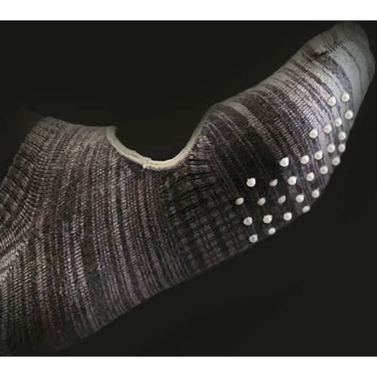 A grey marled yoga and Pilates sock featuring anti-skid dots on the sole and a low-cut design.