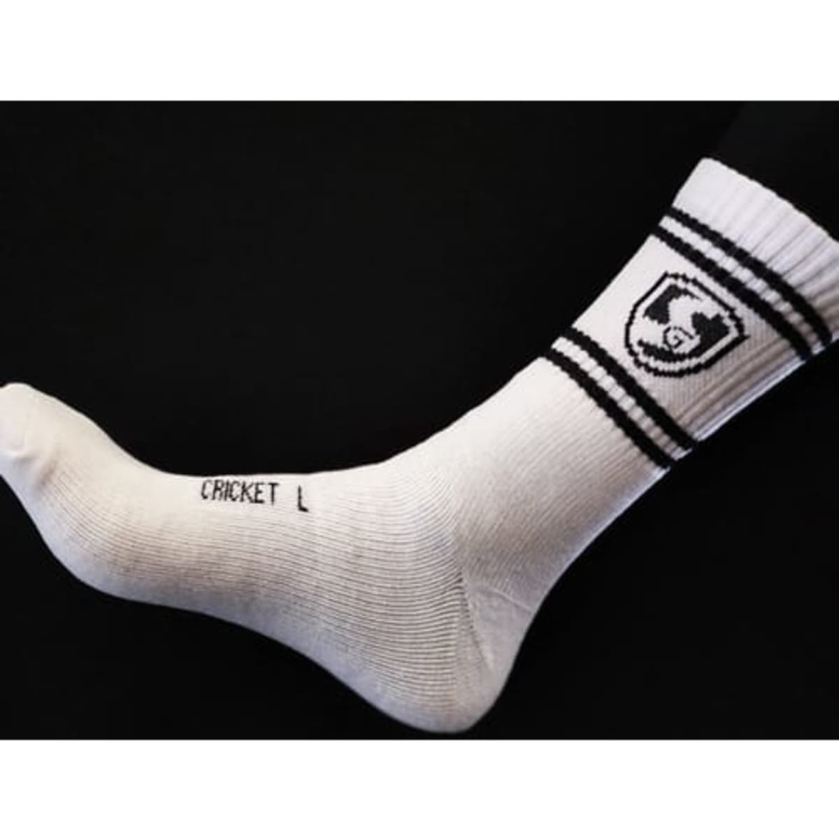 A white cricket sock with black stripes and a logo on the side.