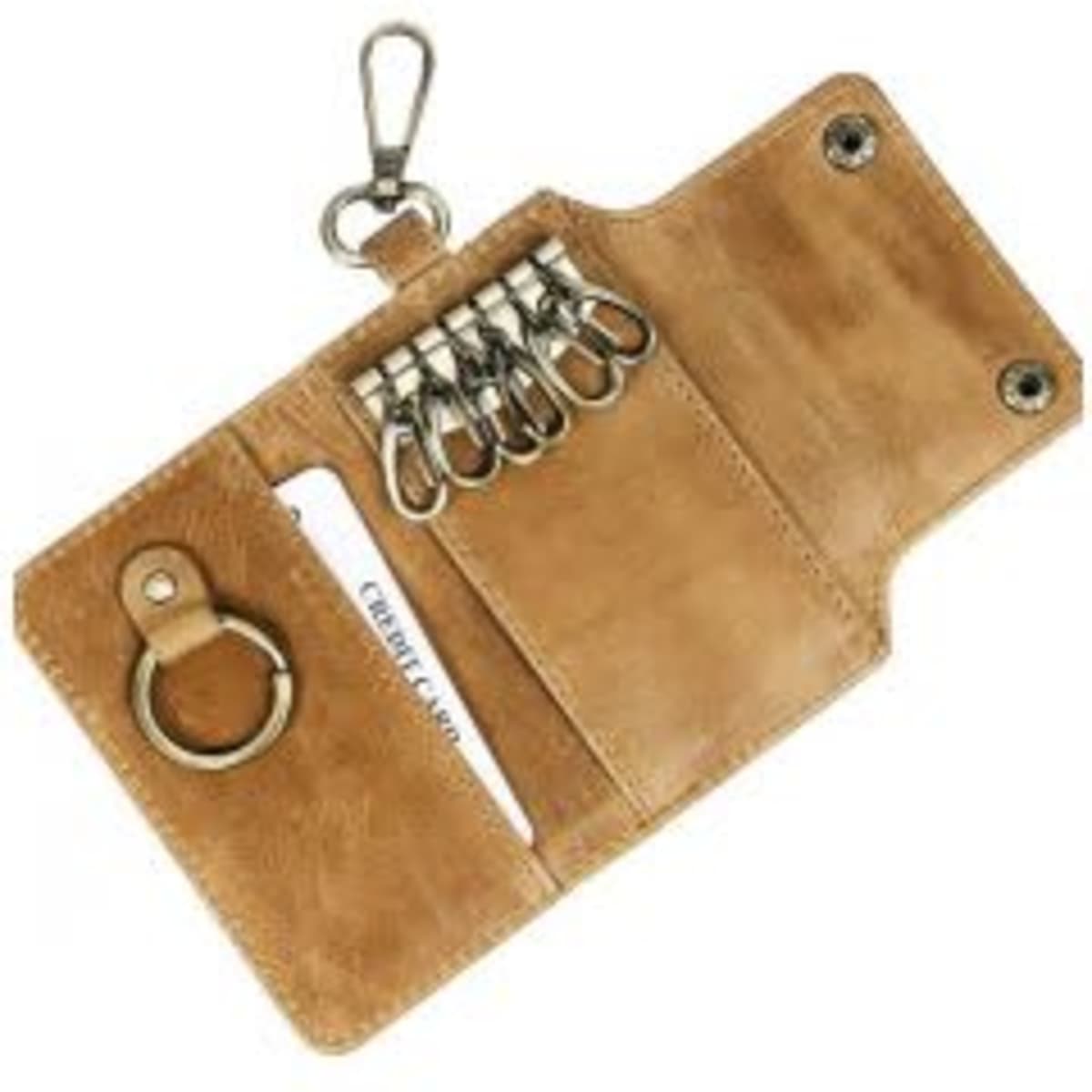 A tan leather key holder featuring multiple key rings and a secure clip, with a slot for cards.