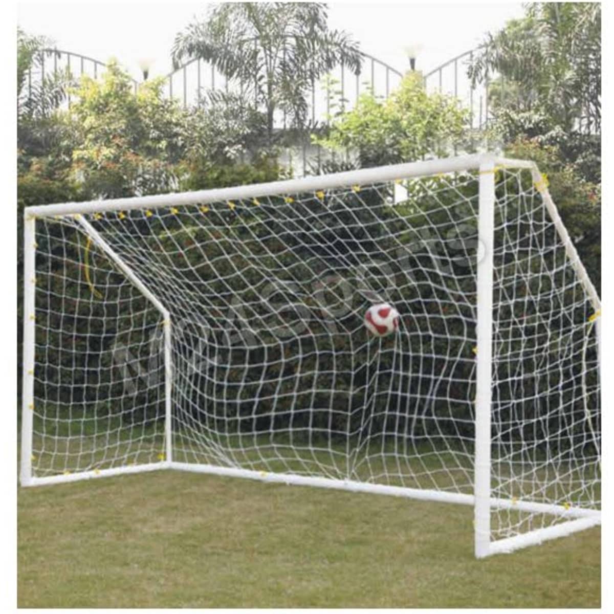 A white soccer goal post with a net, set in a grassy area, featuring a soccer ball in the net.