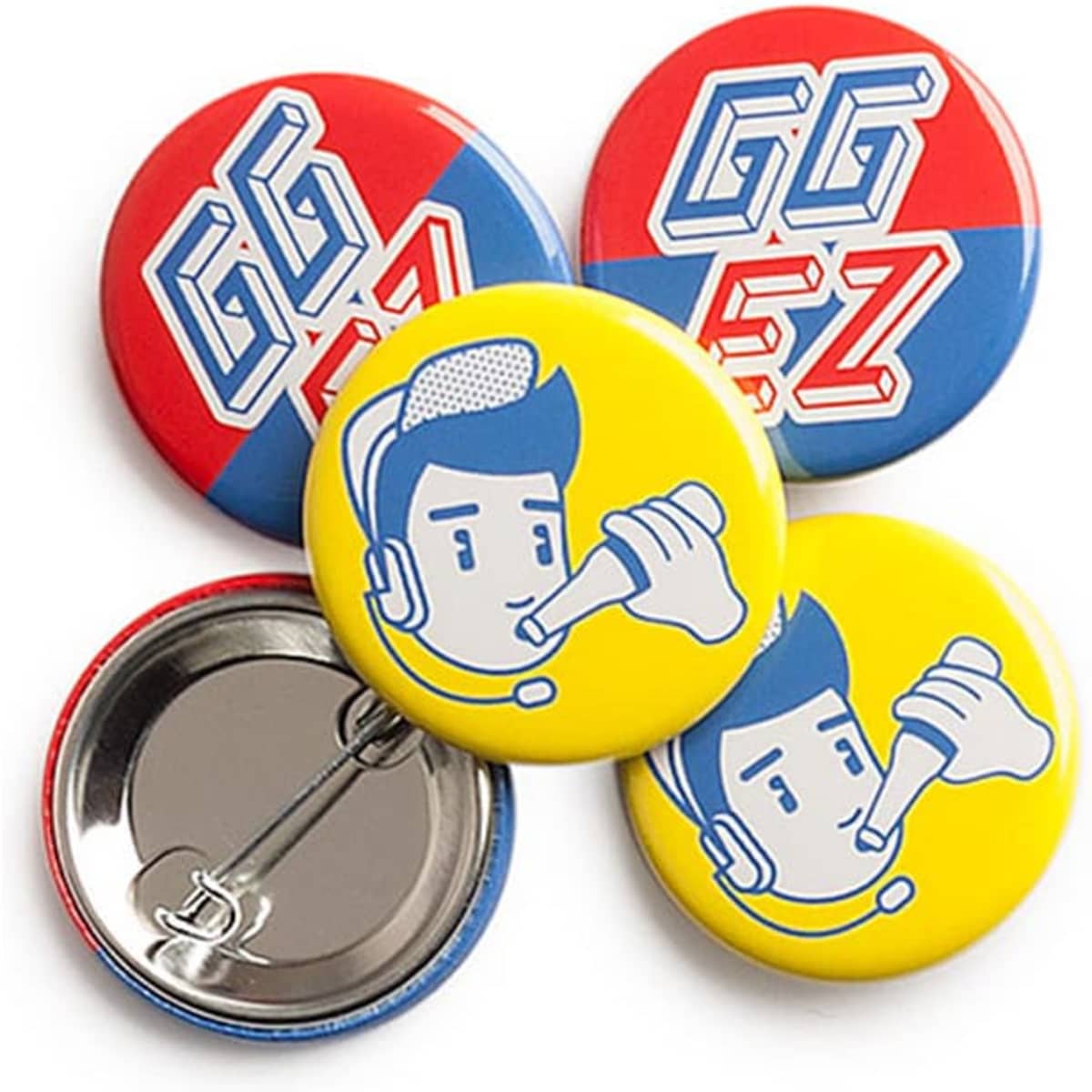 A set of colourful 32mm round badges featuring yellow, red, and blue designs with illustrations and a logo.