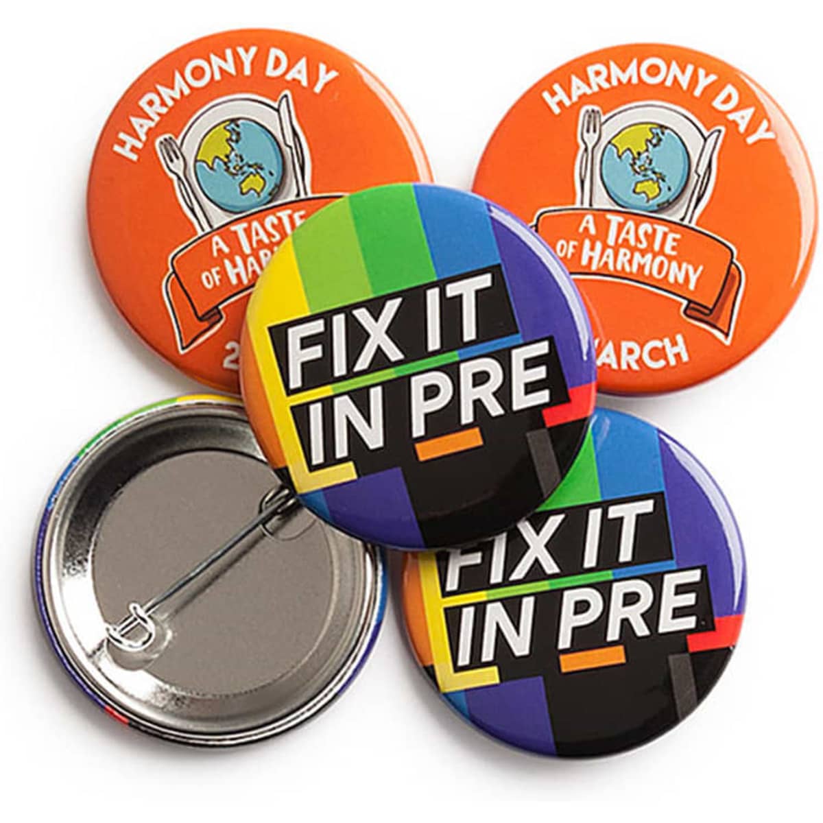 A set of four 38mm round badges featuring vibrant colours, including orange and blue, with various designs and a logo.