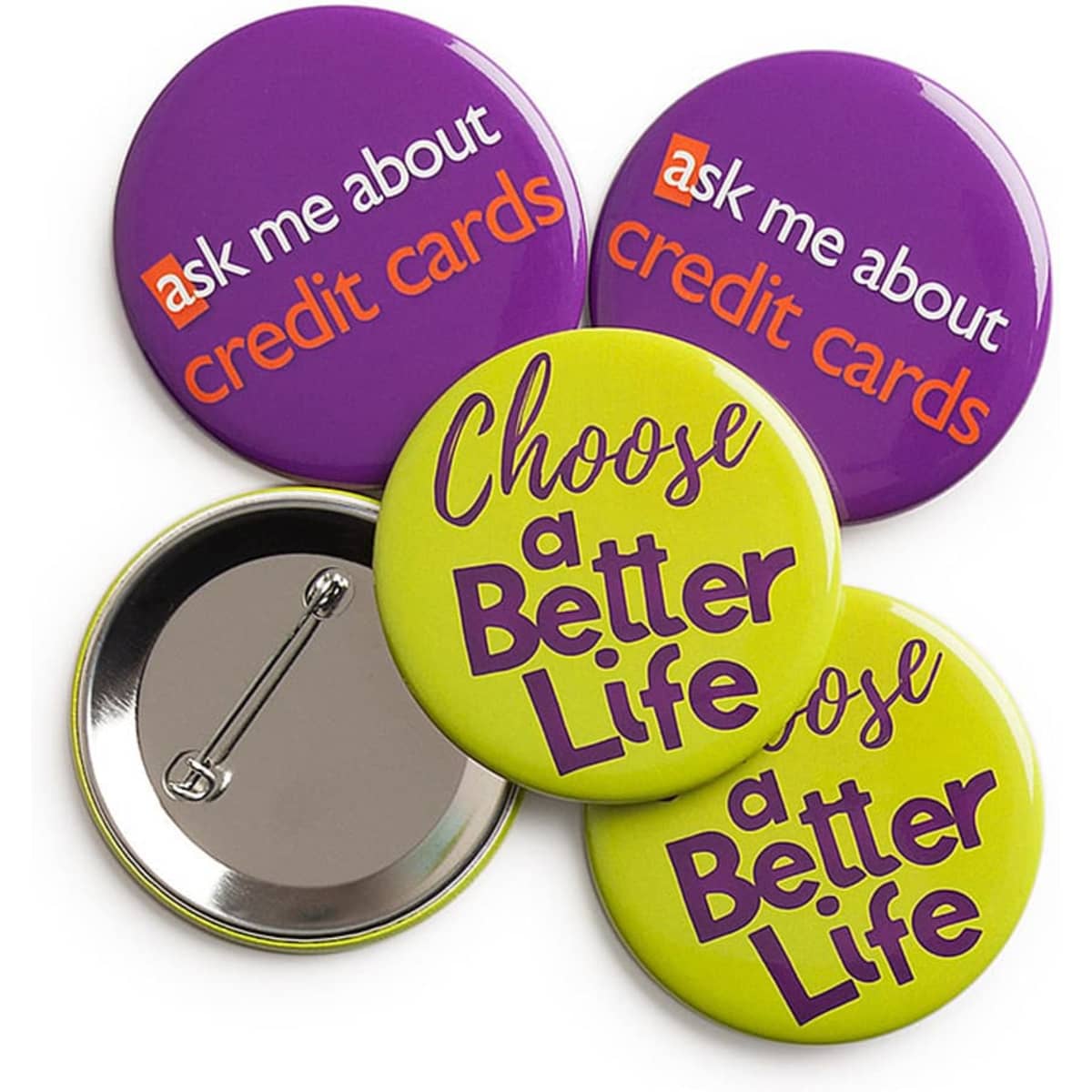 Four round badges in purple and bright green, with a silver backing, featuring various printed designs.