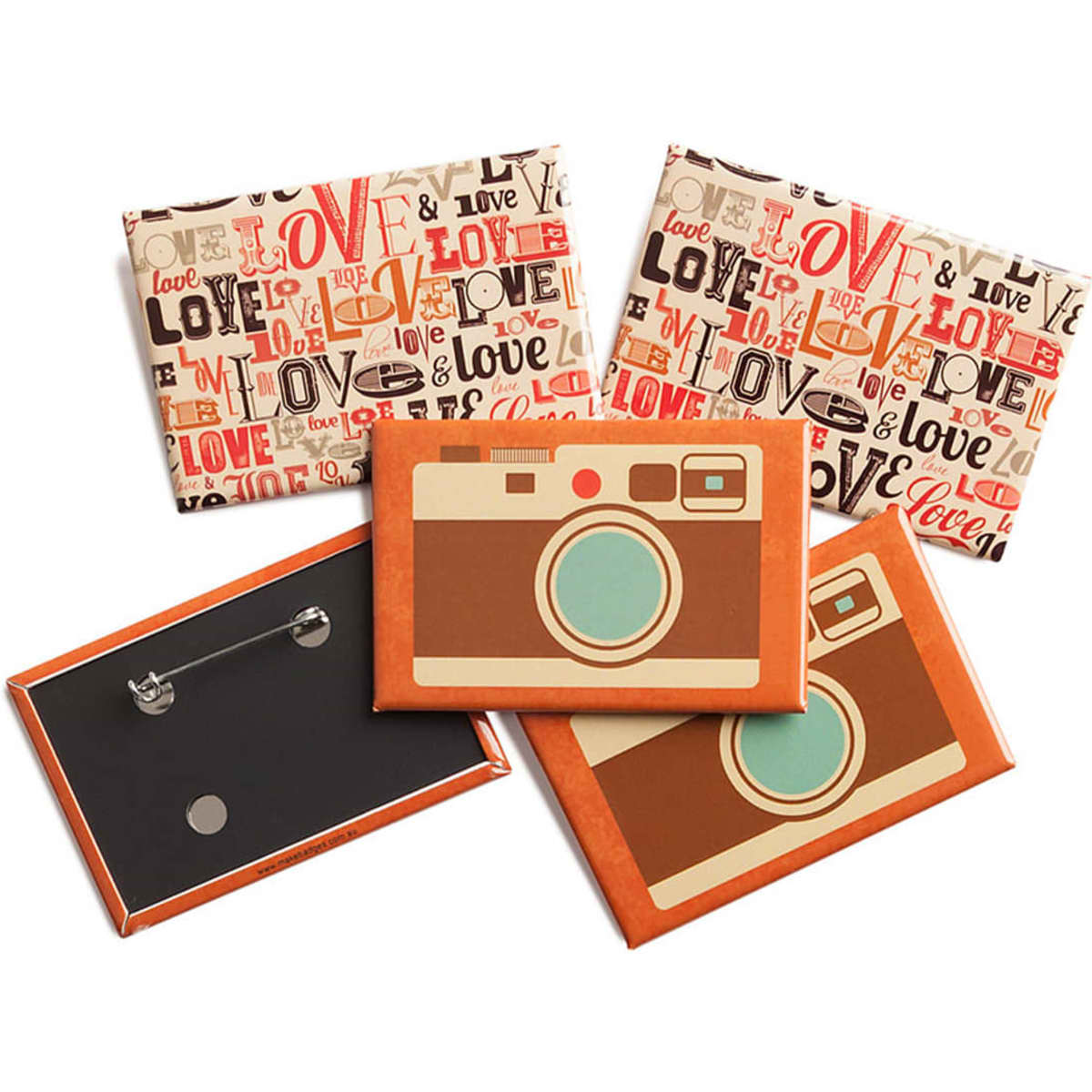 A set of rectangular badges in various designs with a camera motif, featuring vibrant reds and earthy tones.