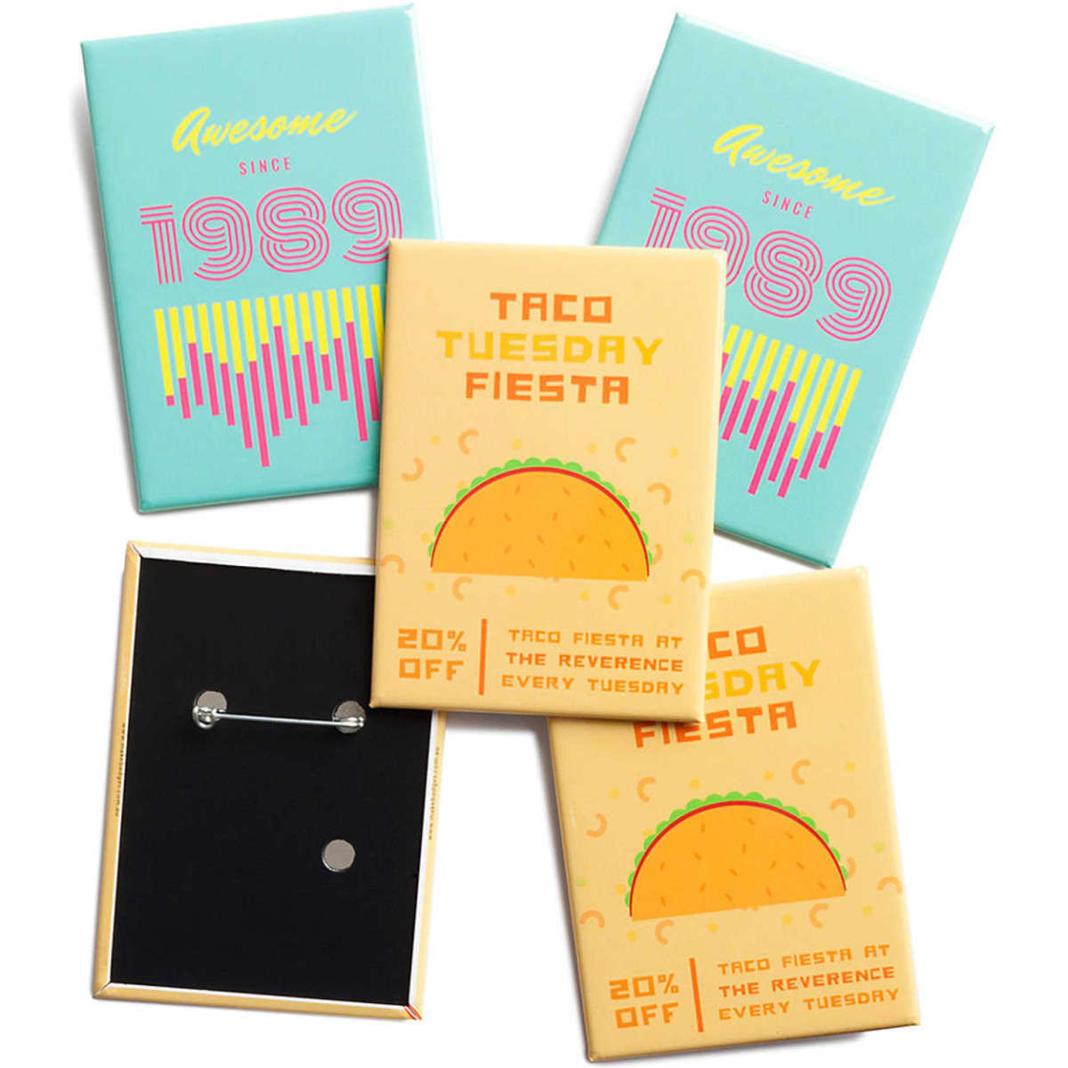 A set of rectangular badges in various colours, featuring designs including a taco and promotional text. Each badge has a pin backing.