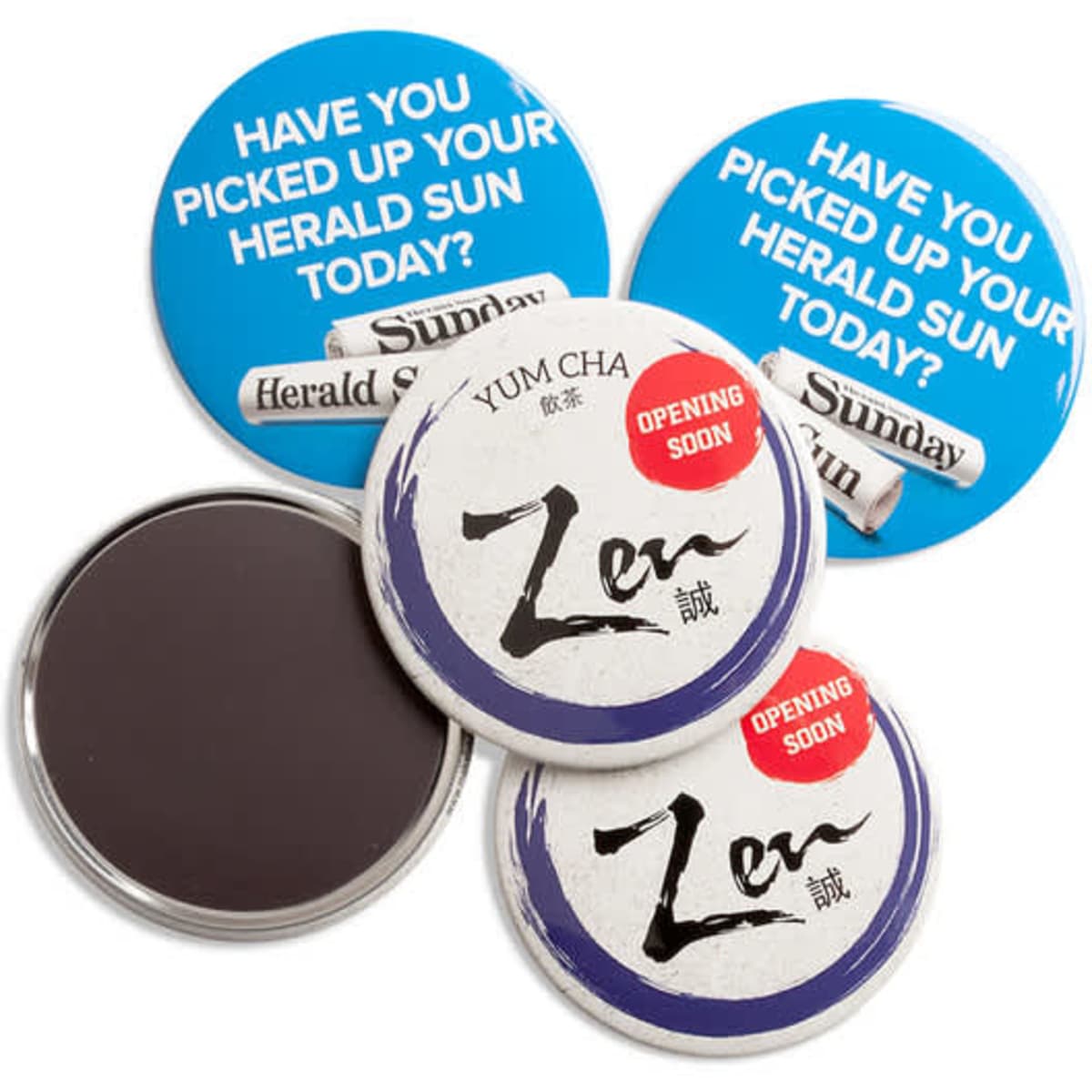 Three round magnets in blue and white, featuring various designs and a logo. One magnet has a black backing.