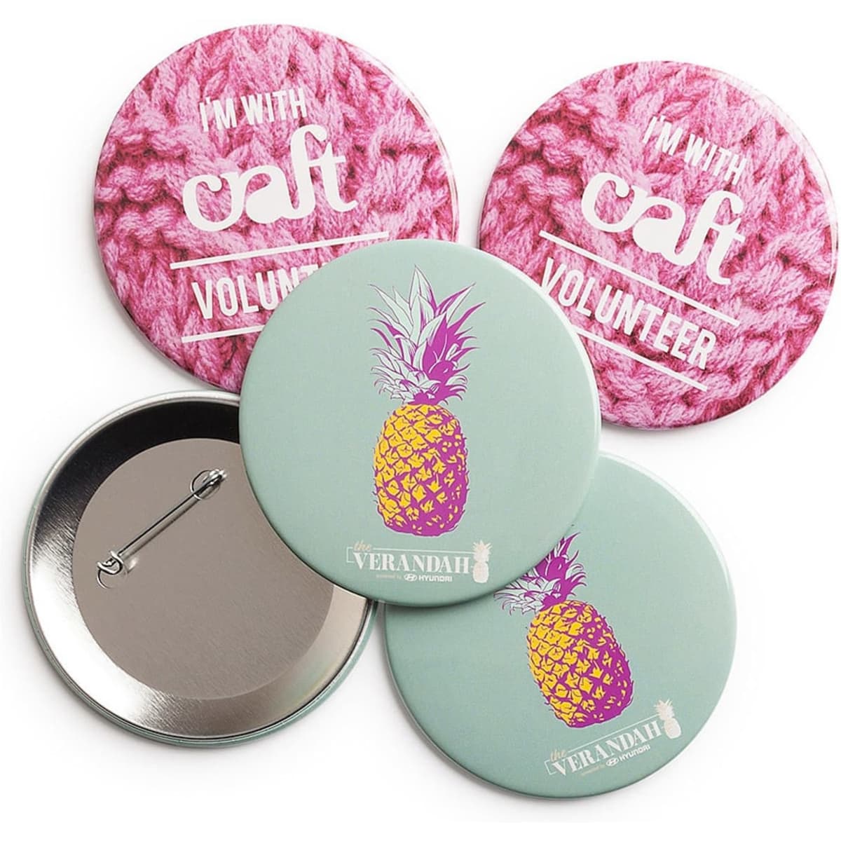 Four round badges, two with a pink knitted background and one featuring a pineapple design on a light green background.