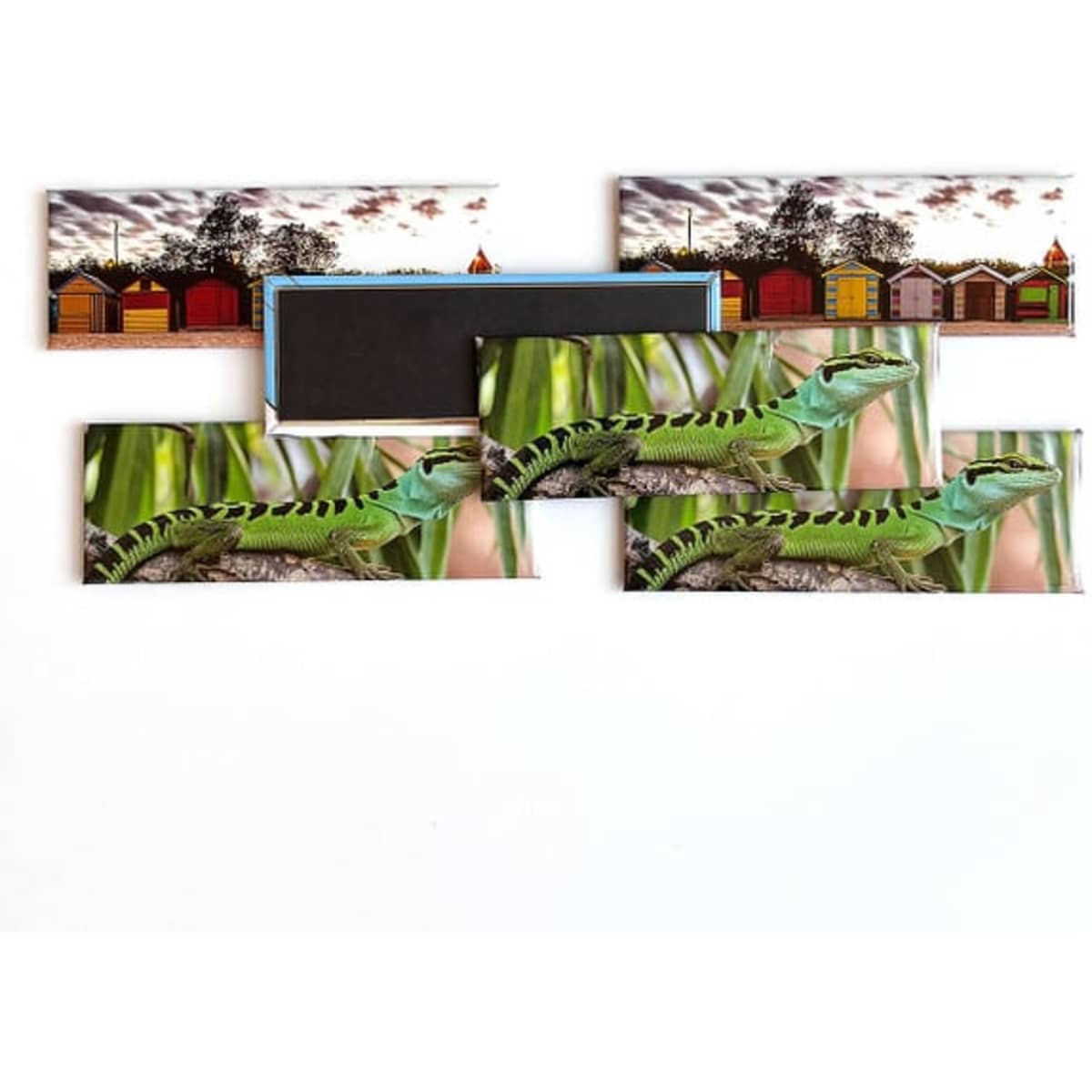 Magnets in various designs, including a vibrant green snake and beach huts, featuring predominantly green and colourful visuals.