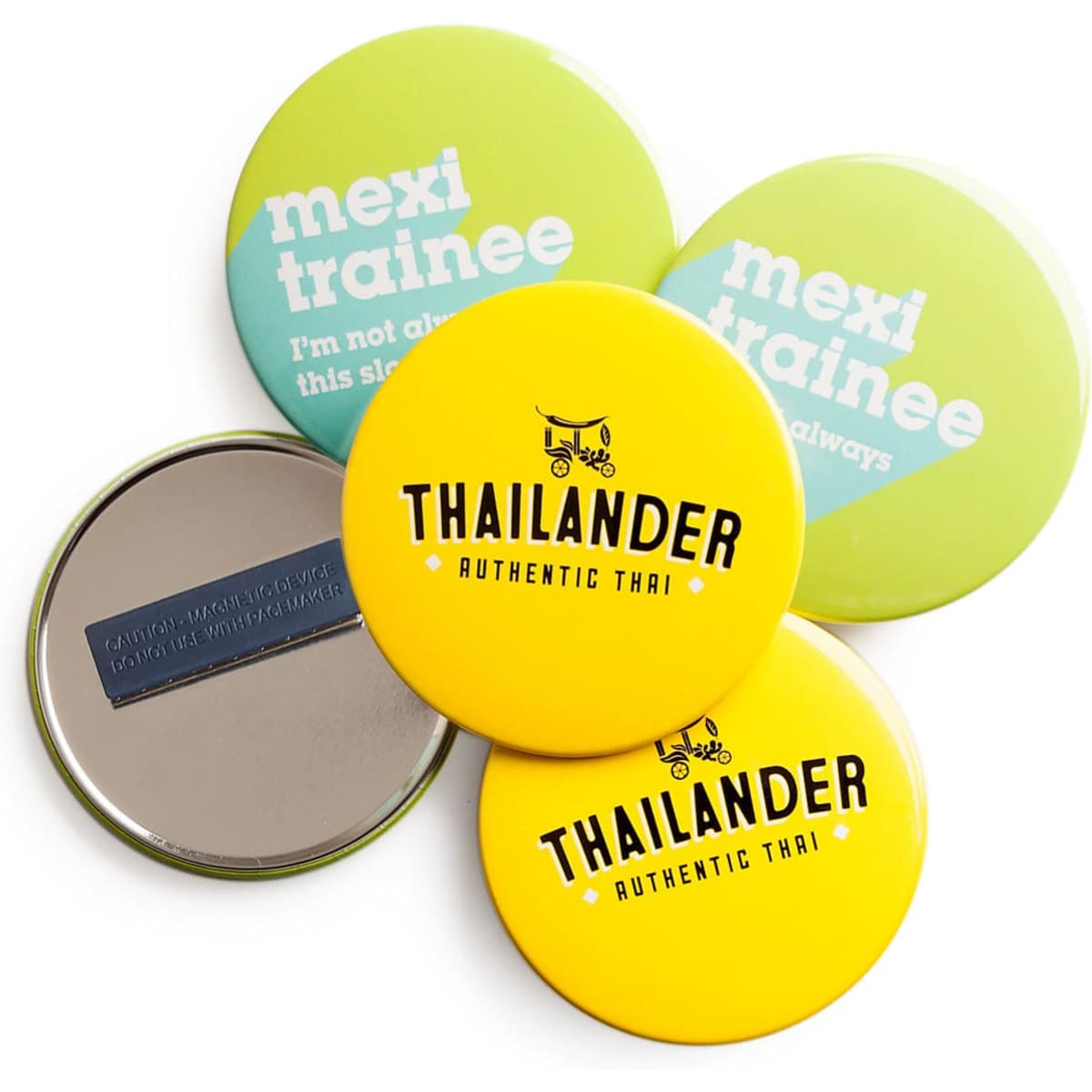 A set of colourful round magnet fastener badges in green and yellow, featuring various designs and a metallic back.