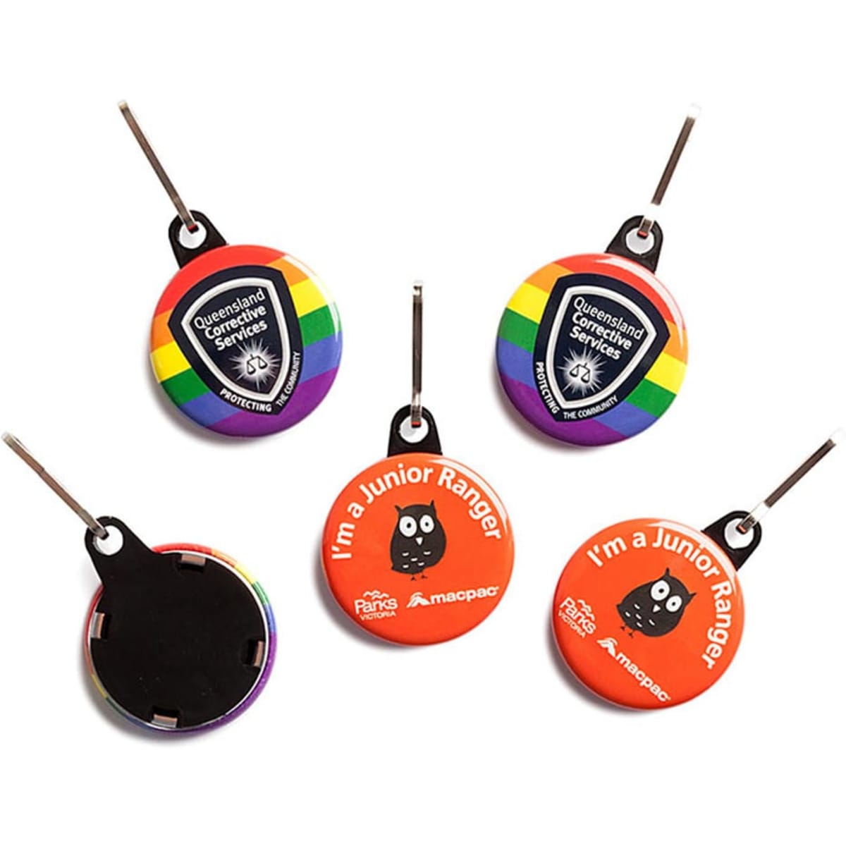 A set of three colourful 32mm round zipper pulls, featuring various logos and designs, including rainbow and red options.