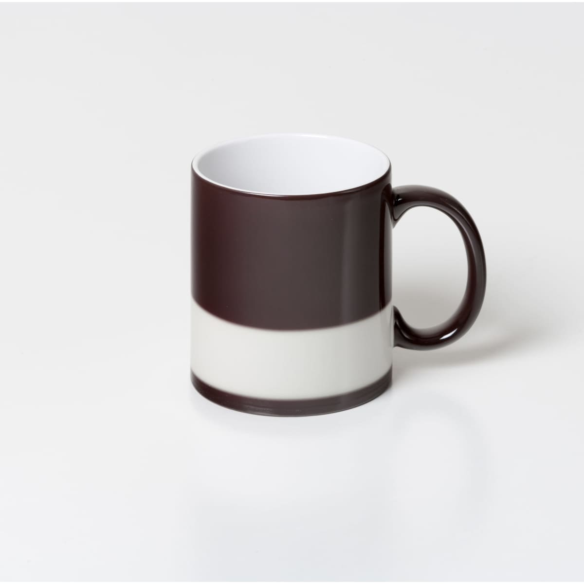 A coffee mug featuring a dark brown exterior with a contrasting white band and a matching dark brown handle.