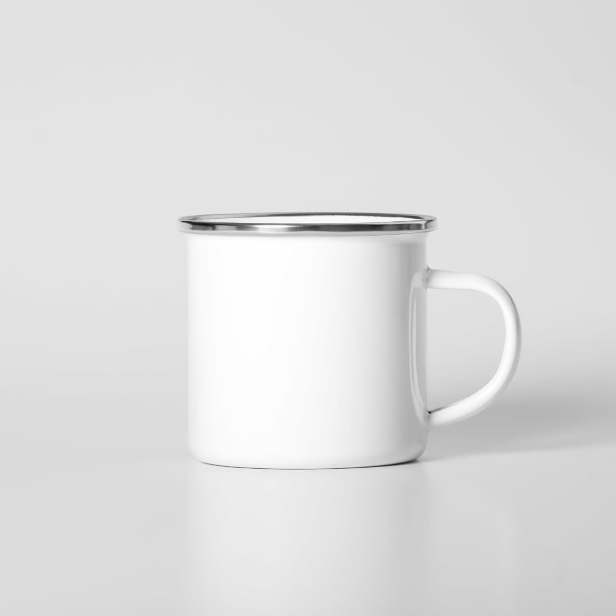 A white enamel mug with a silver rim and a sturdy handle, featuring a logo.