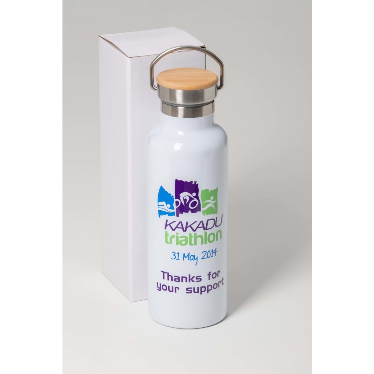 A drink bottle in white with a silver lid and wooden handle, featuring branding and a decorative design.