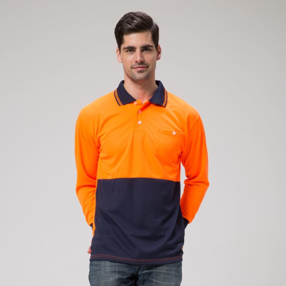 A long-sleeved polo in orange and navy, featuring a pocket and a logo.