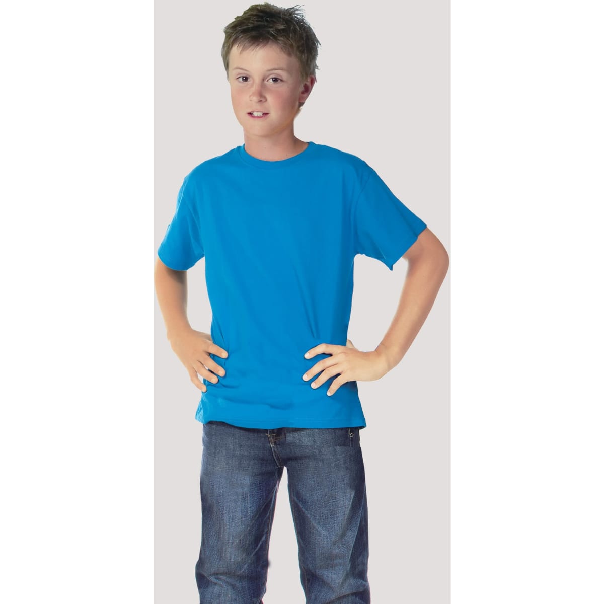 A blue junior T-shirt worn by a child, standing with hands on hips, against a plain background.