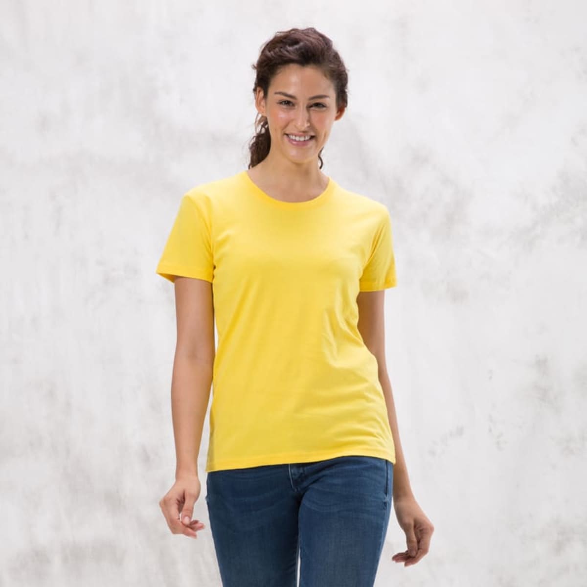 A yellow ladies' tee with a classic fit, featuring short sleeves and a round neckline, against a neutral background.
