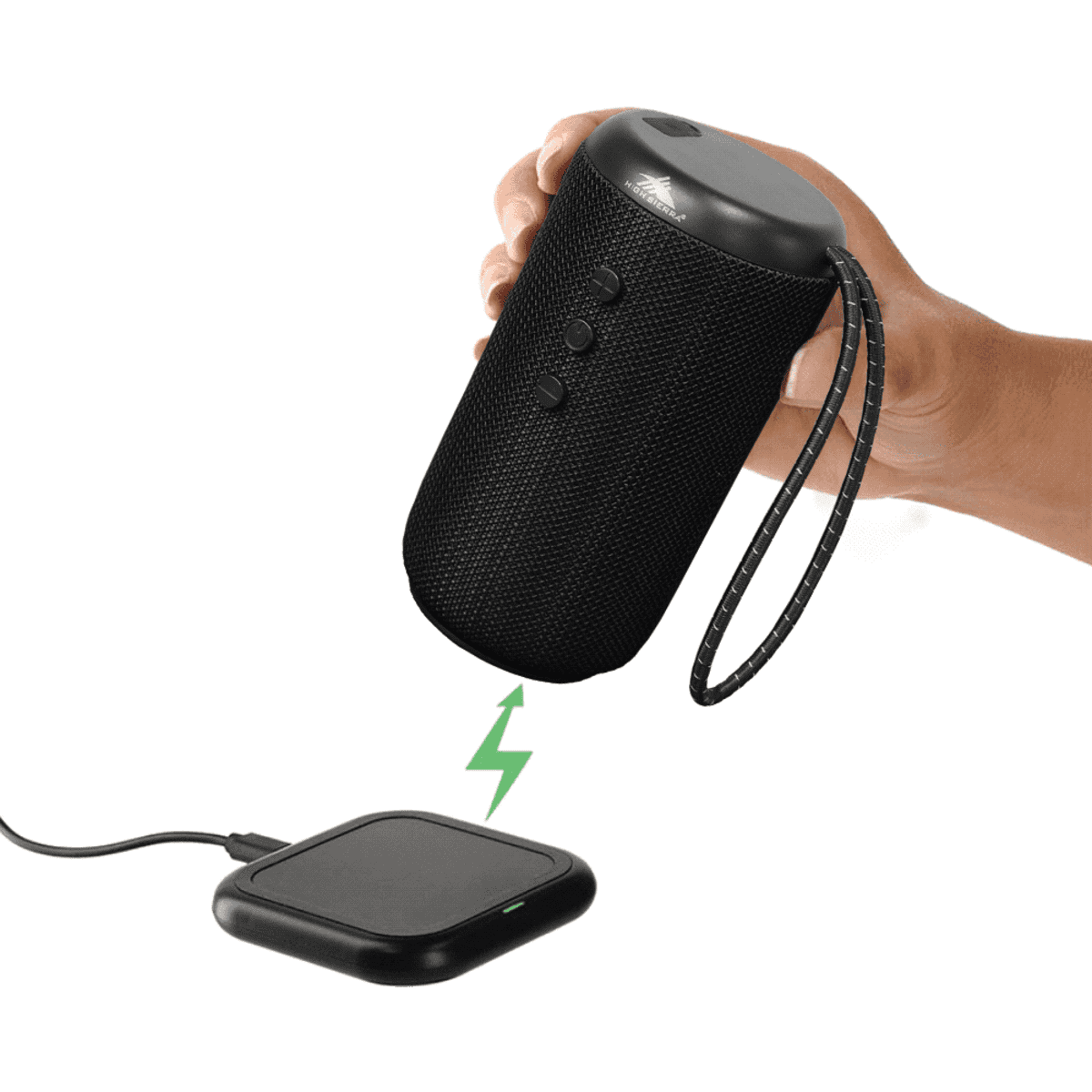 A black outdoor Bluetooth speaker held above a charging pad, featuring a textured finish and a carrying strap.