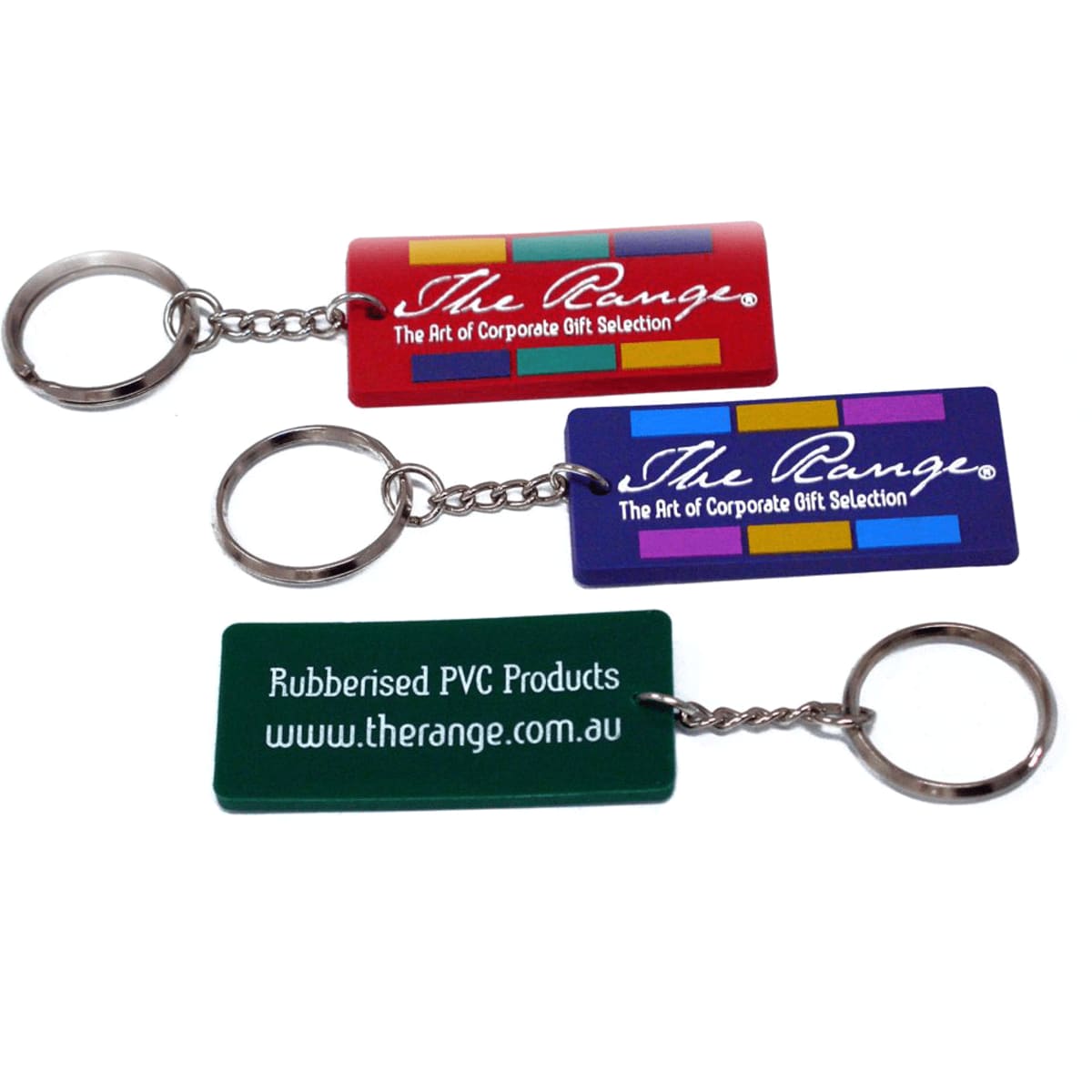 A set of three custom PVC keyrings in red, blue, and green, each with a metal keyring attachment and branding.