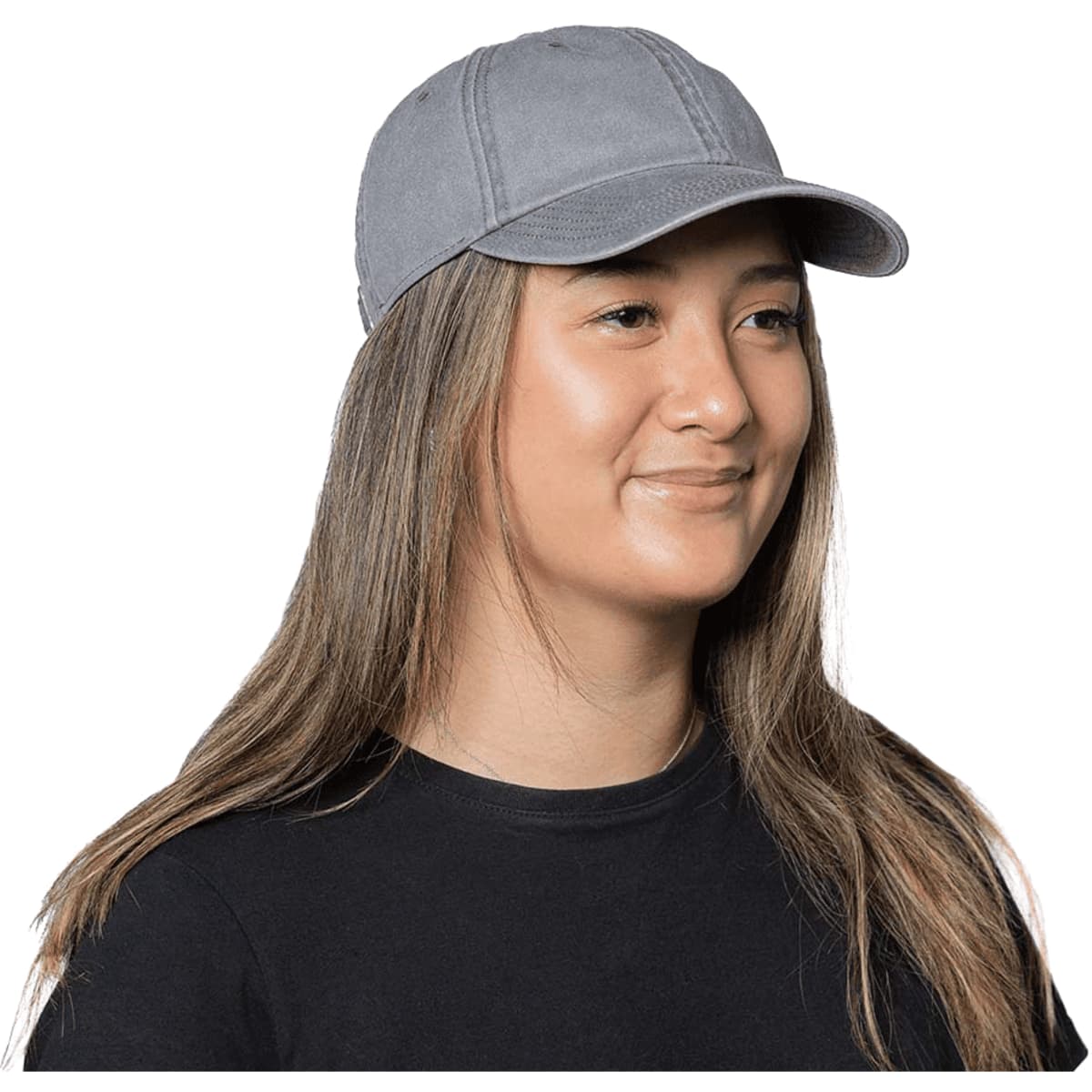 A grey organic washed cotton cap with a curved brim, worn by a woman with long hair. The cap includes a logo.